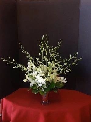 Orchids in a small silver vase