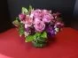low arrangement with purple flowers, purple roses, orchids, alstromeria and stock