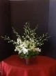 Orchids in a small silver vase