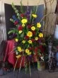 Colorful Funeral Flowers with Yellow Daisies and Red Roses
