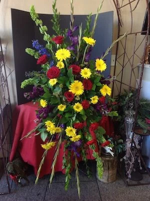 Colorful Funeral Flowers with Yellow Daisies and Red Roses